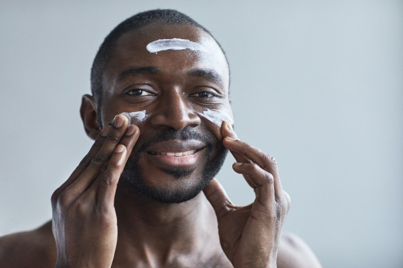 A man applying skin cream